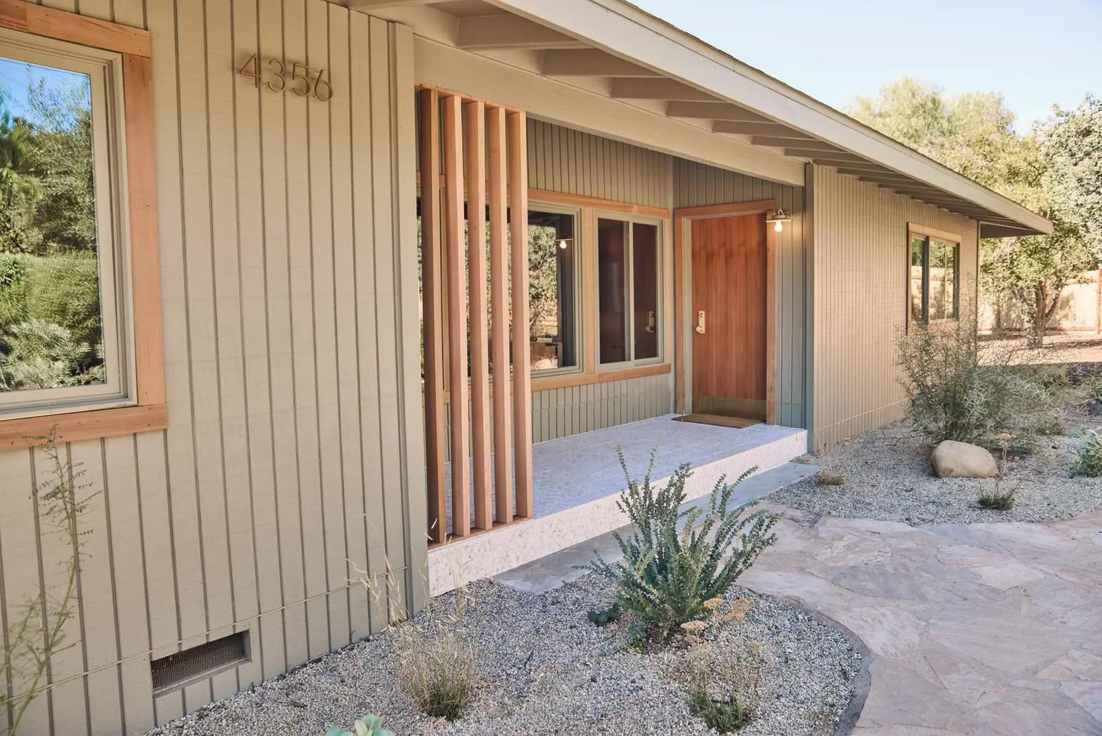 Entry porch with board-and-batten siding and a wood screen, Ojai East End