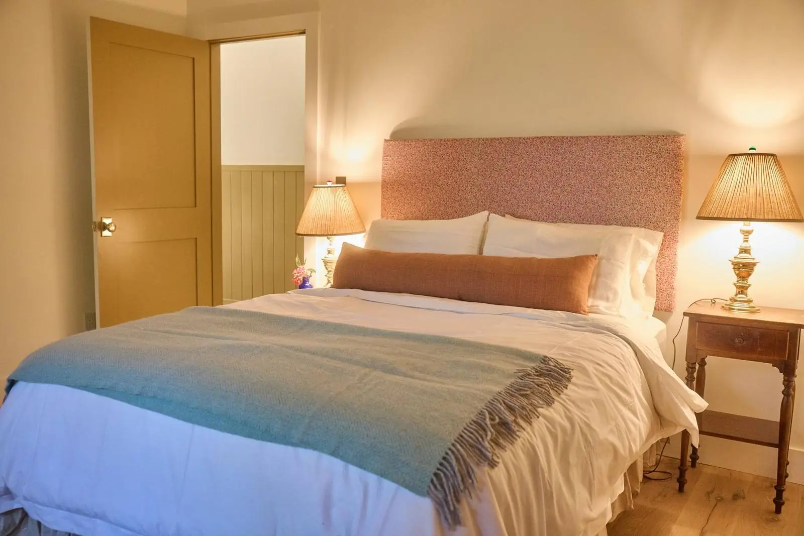 Bedroom with an upholstered headboard and table lamps, Ojai Gridley
