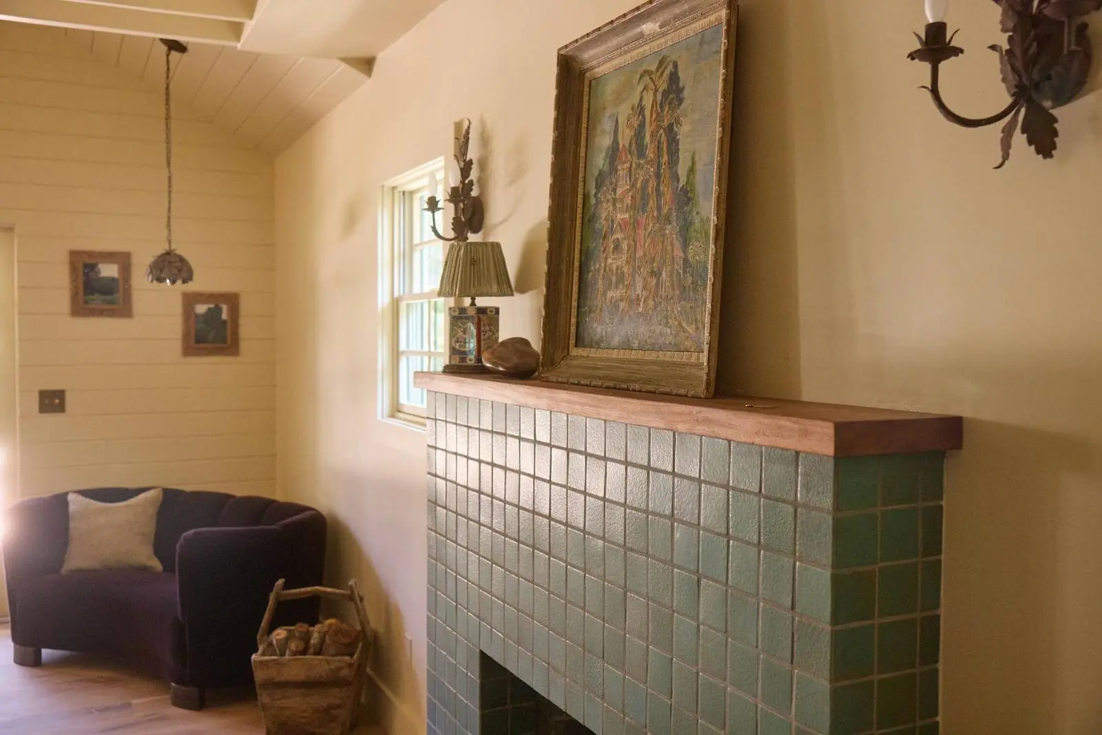 Green tiled fireplace with a wood mantel, Ojai Gridley