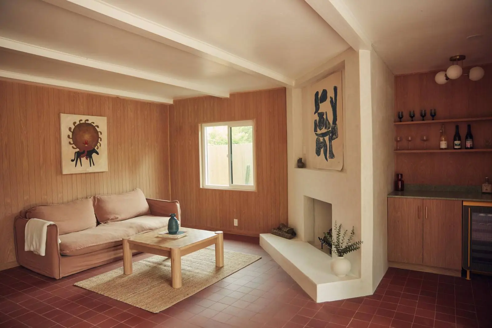 Living room with white oak paneling, a plaster fireplace and a built-in bar, Ojai Woodland