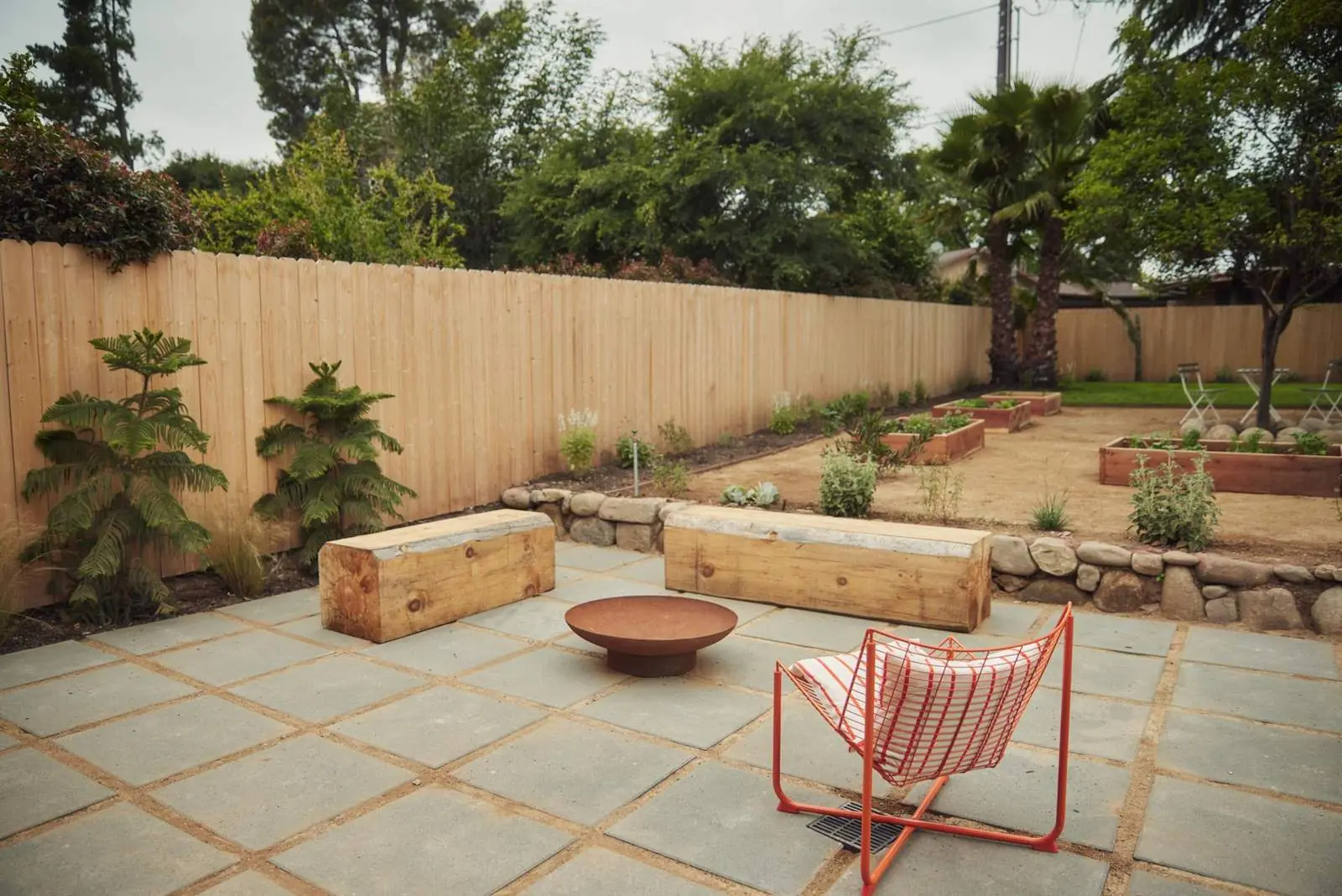 Back patio with stone pavers, a fire bowl and new plantings, Ojai Woodland
