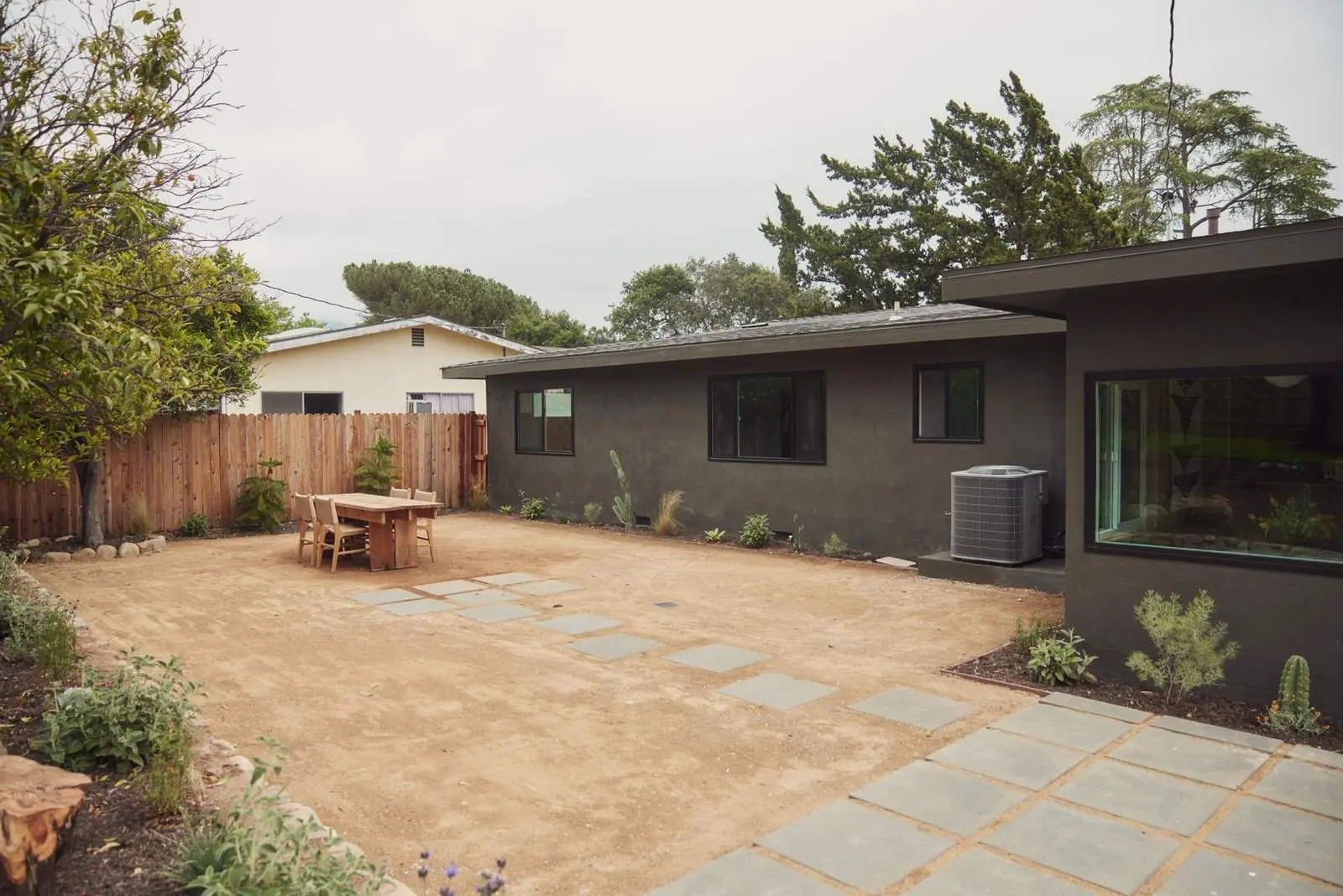 Dark-sided ranch house and its new backyard, Ojai Woodland