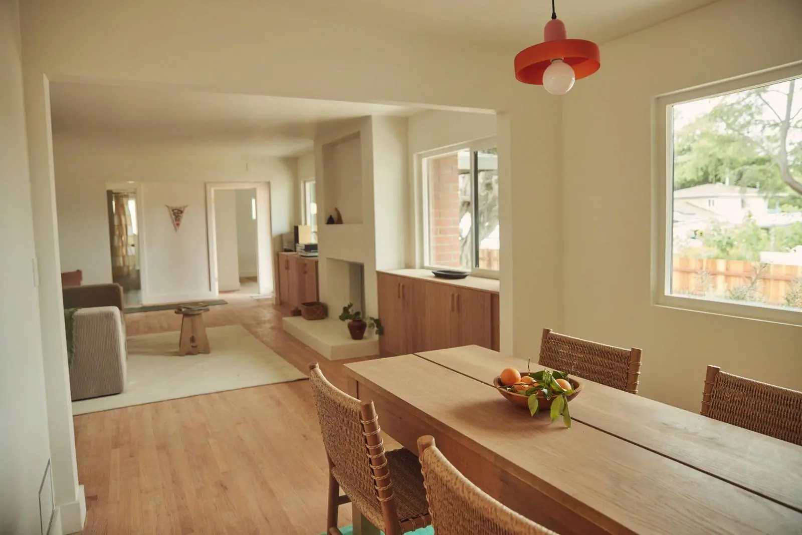 Dining room with a long wood table under a red pendant, Ojai Woodland
