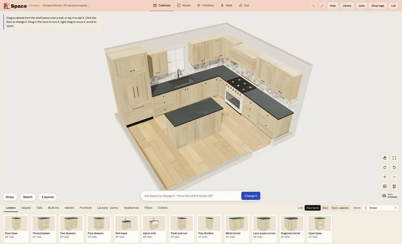 Space on a laptop: a 3D kitchen in rift white oak with soapstone counters, an island and a range, with a shelf of cabinets below to drag into the room
