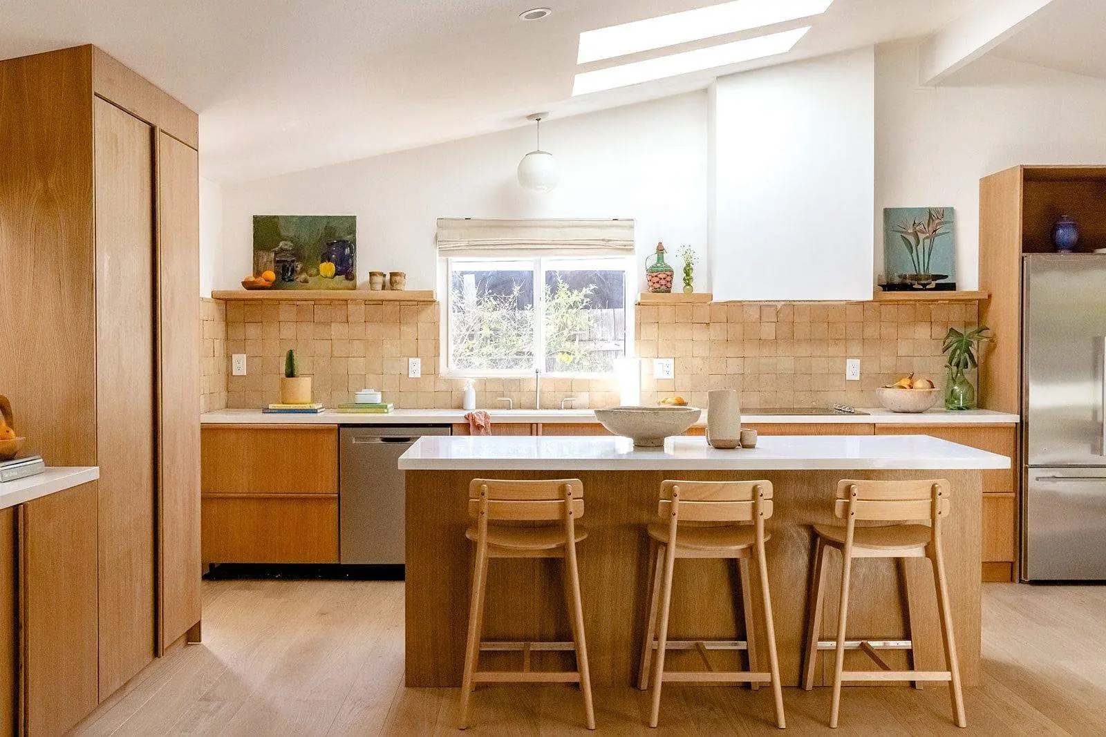 A white oak kitchen with an island and stools